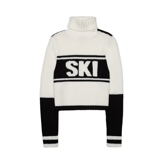 white ski sweater with black letters and wrist cuffs