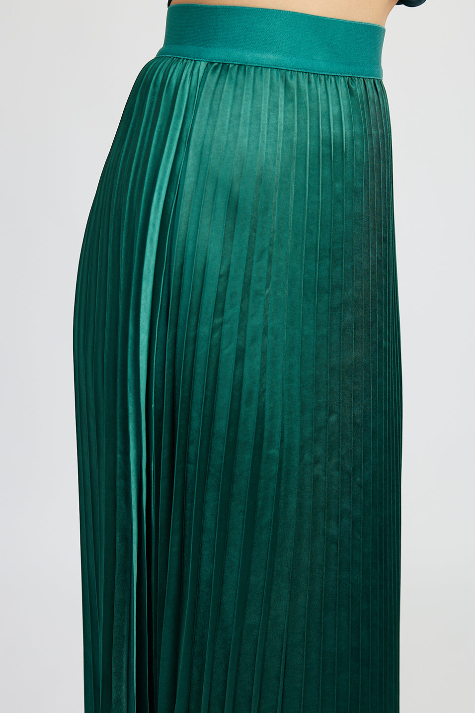 emerald green satin pleated midi skirt with asymetrical hem