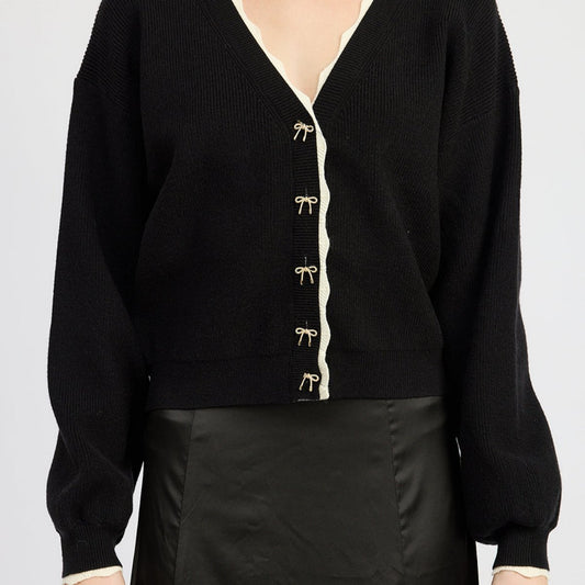 black cardigan with gold bow buttons and puffed long sleeves