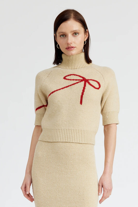 beige turtleneck sweater with short sleeves and red bow silhouette