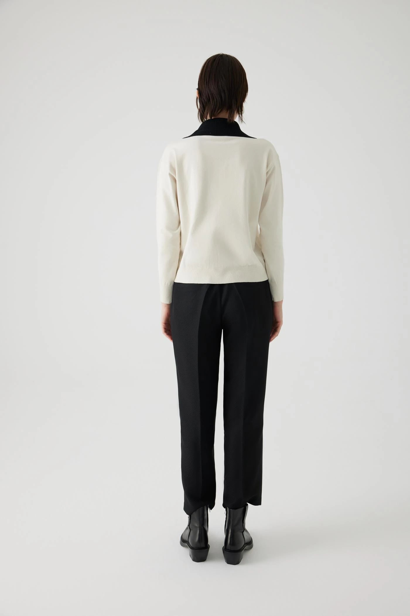 ivory knit pullover with black contrasting collar and bejeweled buttons