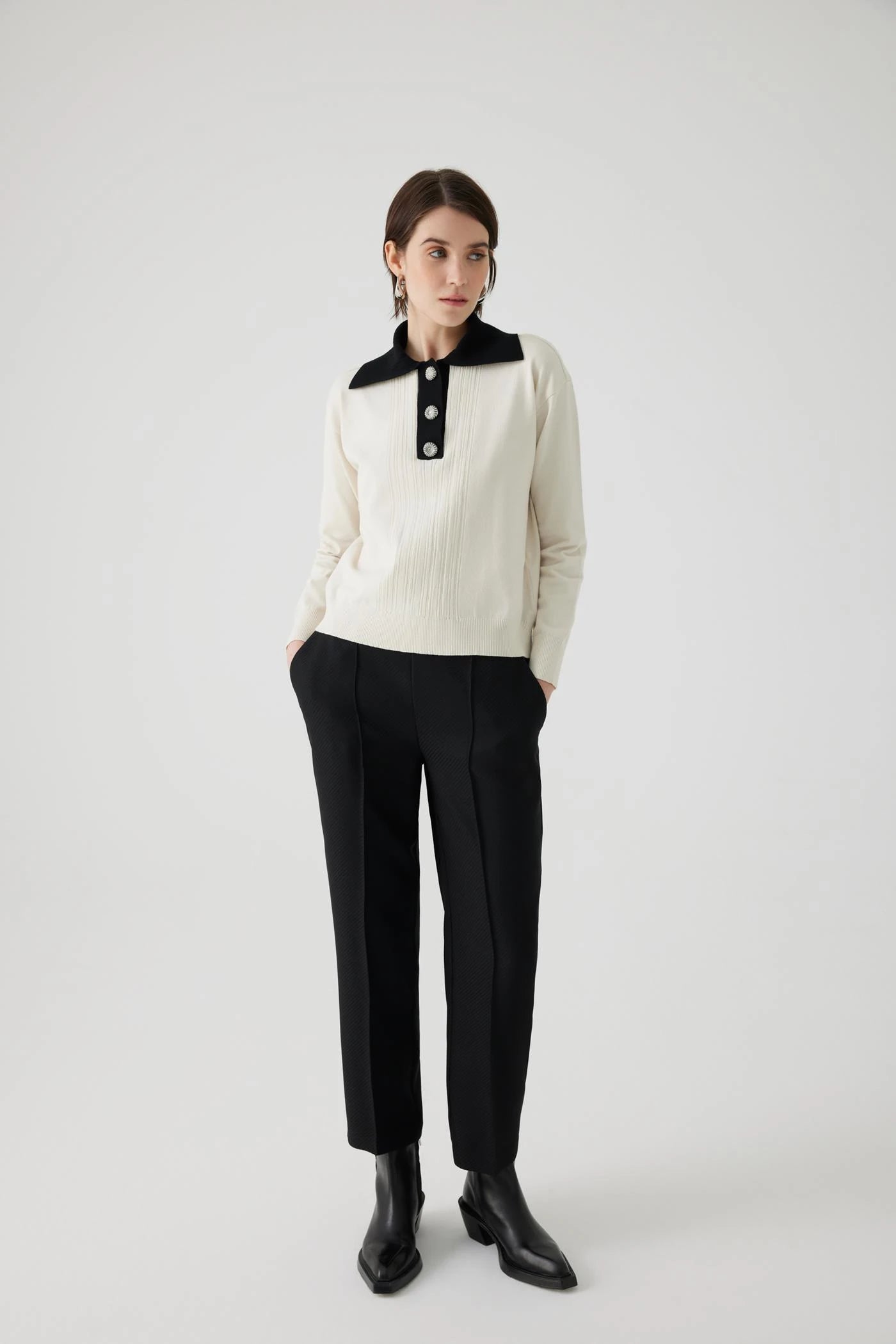 ivory knit pullover with black contrasting collar and bejeweled buttons