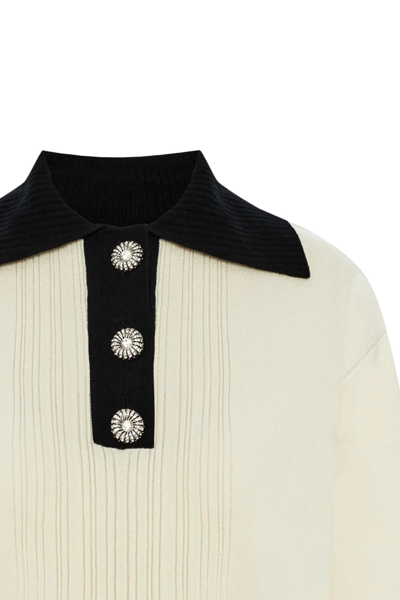 ivory knit pullover with black contrasting collar and bejeweled buttons