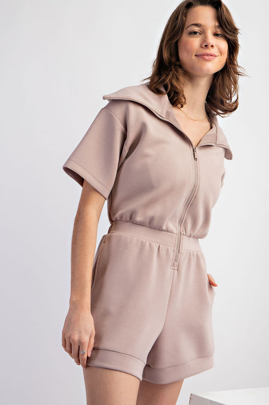 beige athleisure romper with short sleeves and half zip and sailor collar