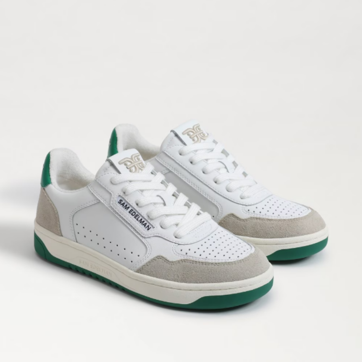 white sneakers with green soles and suede accents