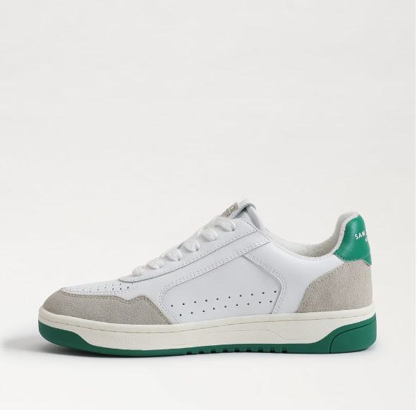 white sneakers with green soles and suede accents