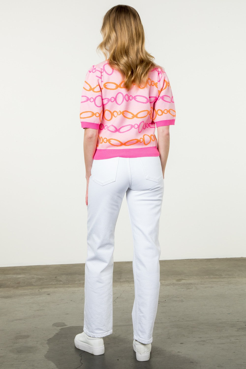 pink short sleeve sweater with pink and orange chain pattern