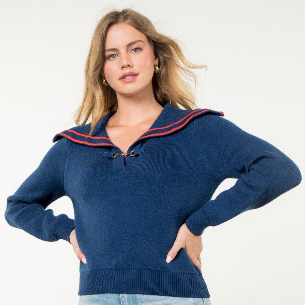 navy sweater with orange piping on a sailor collar and long sleeves and front clasp