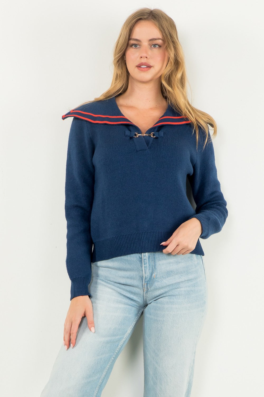 navy sweater with orange piping on a sailor collar and long sleeves and front clasp