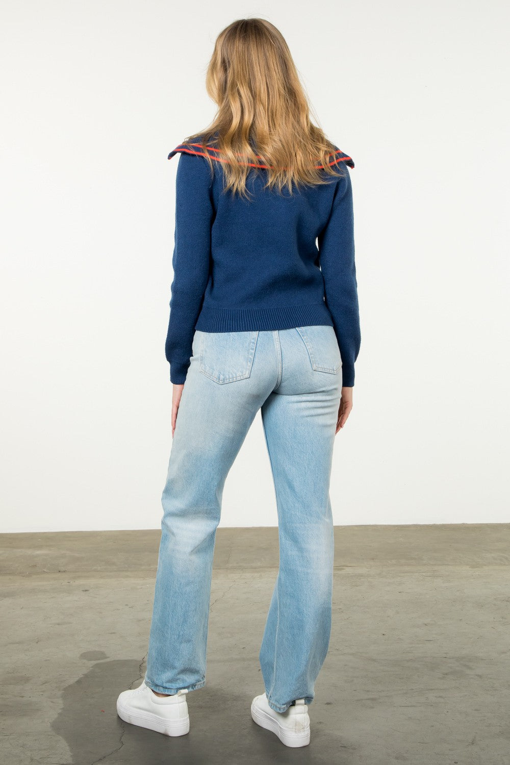 navy sweater with orange piping on a sailor collar and long sleeves and front clasp