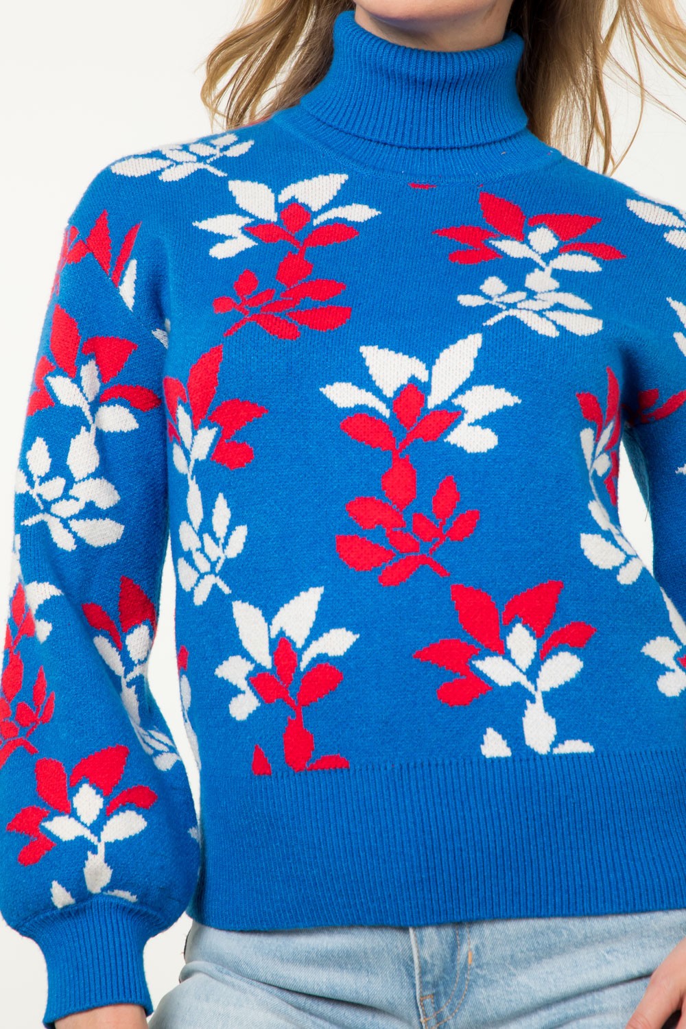 bright blue turtleneck sweater with red and white abstract floral pattern and puffed long sleeves