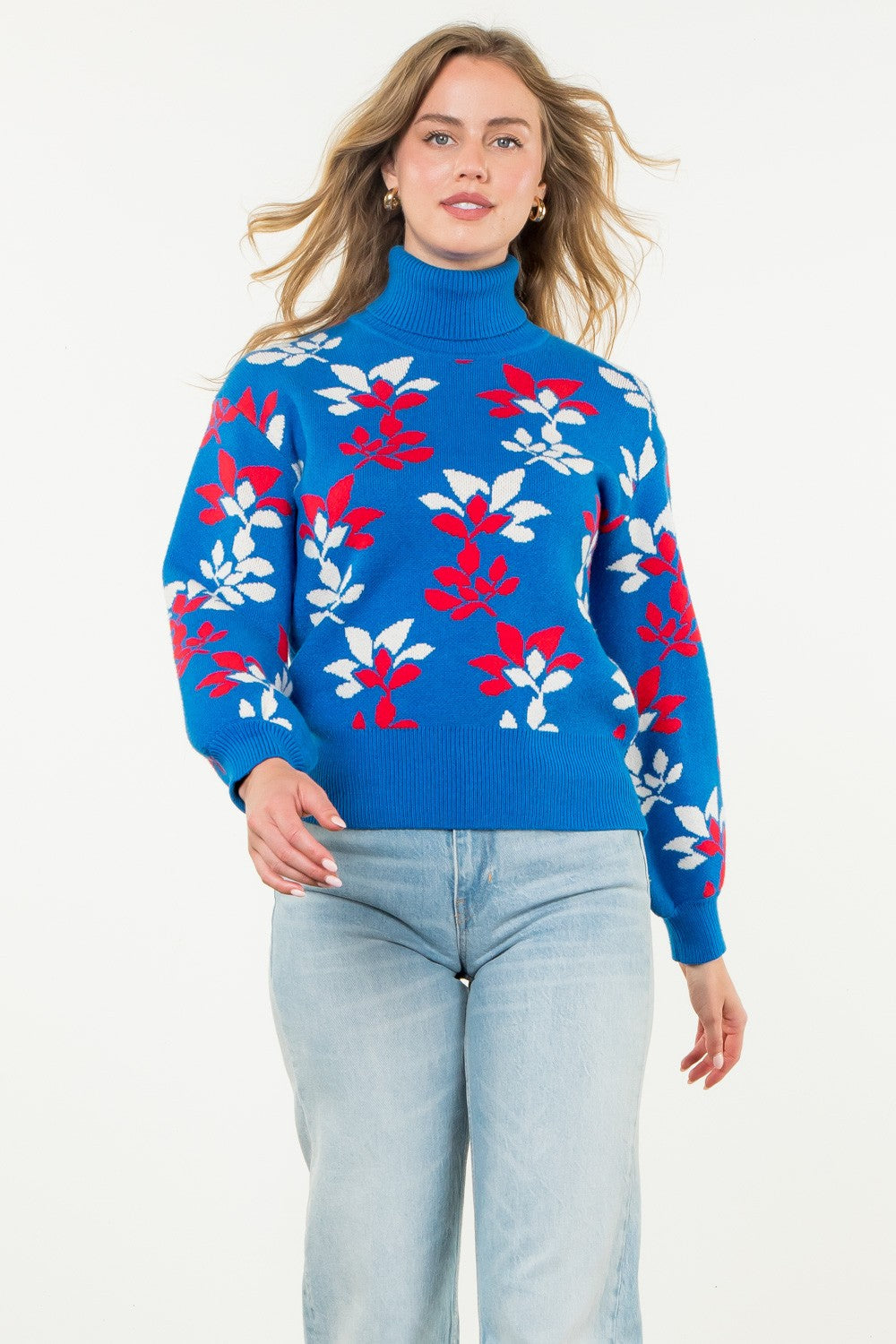 bright blue turtleneck sweater with red and white abstract floral pattern and puffed long sleeves