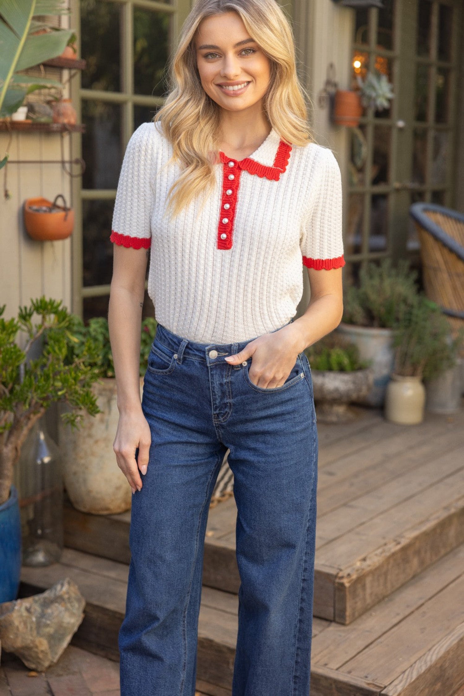 ivory knit short sleeve polo top with red trim, collar and pearl buttons